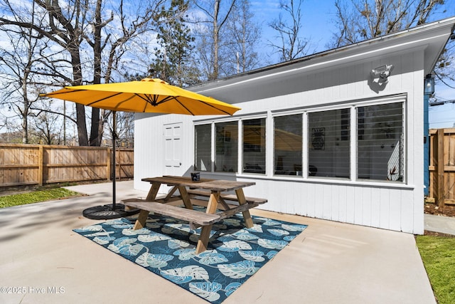 view of patio featuring fence and outdoor dining space