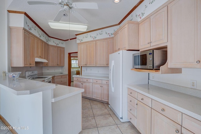 kitchen featuring stainless steel microwave, light brown cabinets, electric range, and ornamental molding