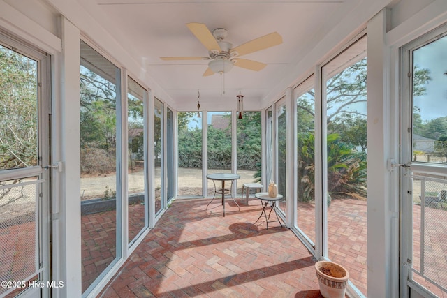 sunroom / solarium featuring a wealth of natural light and ceiling fan