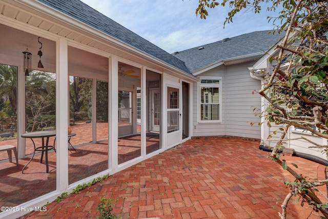 view of patio featuring a sunroom