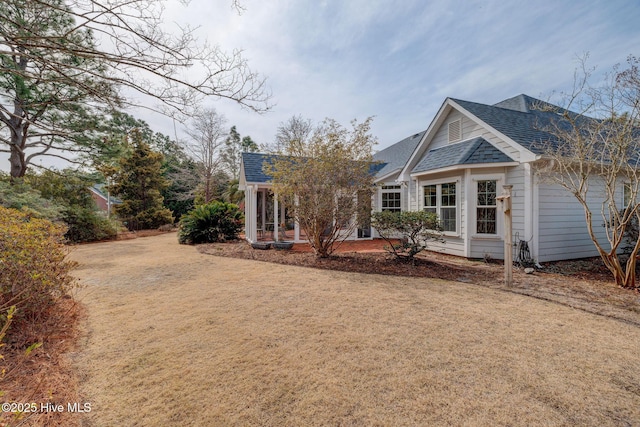 back of property with a shingled roof