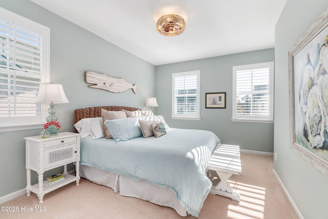 carpeted bedroom featuring baseboards