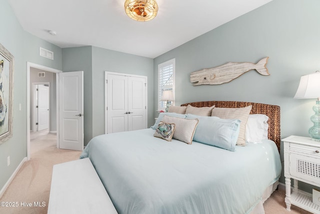 bedroom with light colored carpet, visible vents, a closet, and baseboards