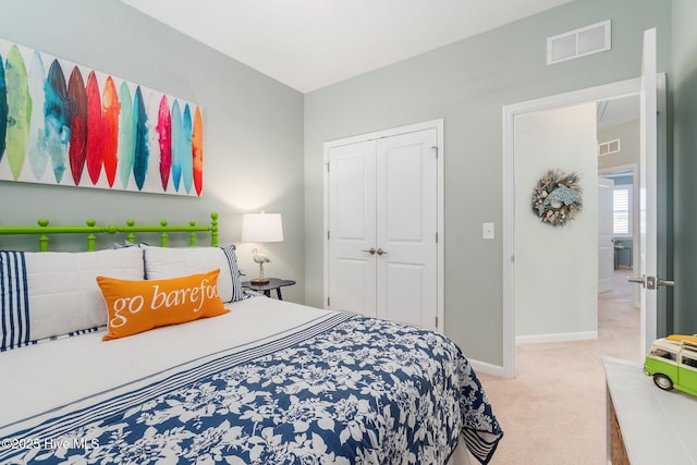 carpeted bedroom with a closet, visible vents, and baseboards