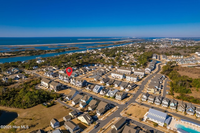 drone / aerial view featuring a residential view and a water view