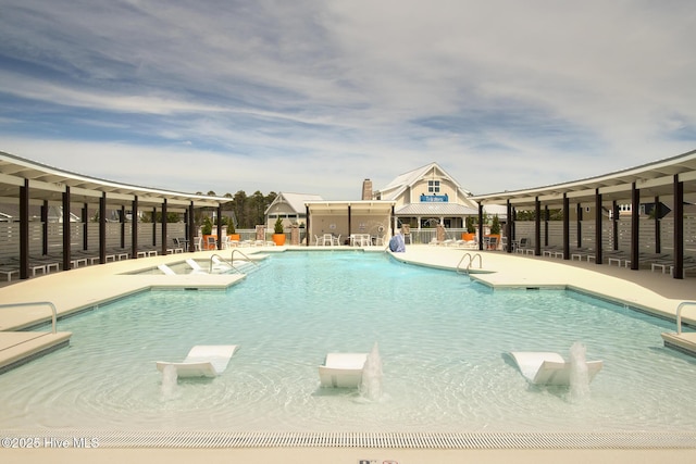 community pool featuring a patio and fence