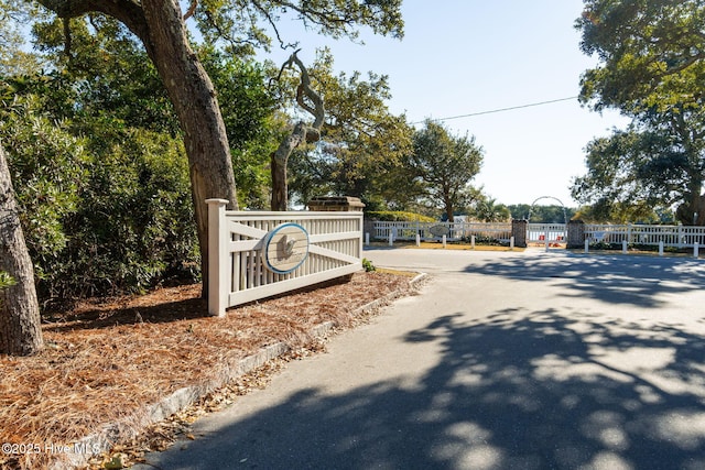 community sign with a gate and fence