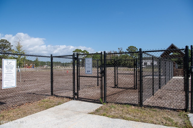 view of property's community featuring fence and a gate