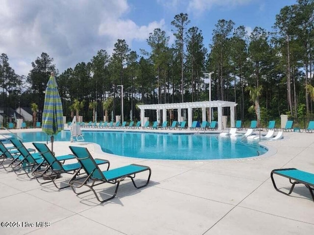 pool featuring a patio, a pergola, and fence