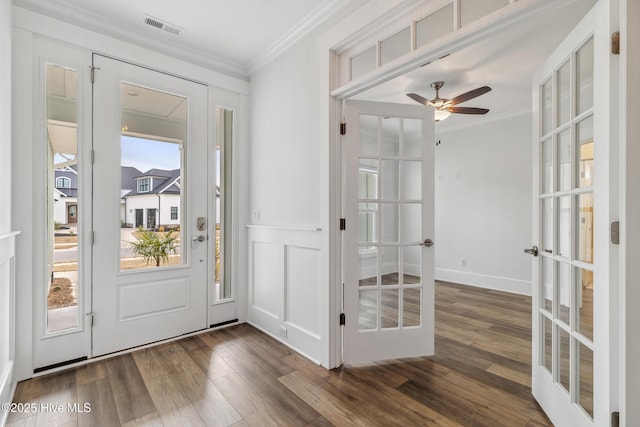 entrance foyer featuring french doors, visible vents, ornamental molding, and wood finished floors