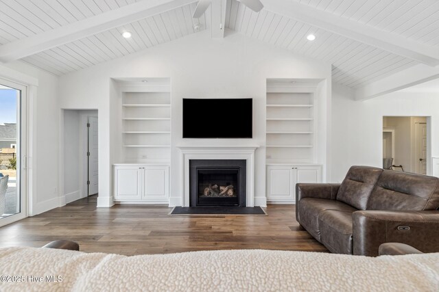 living room featuring built in features, ceiling fan, wood finished floors, and a fireplace with flush hearth