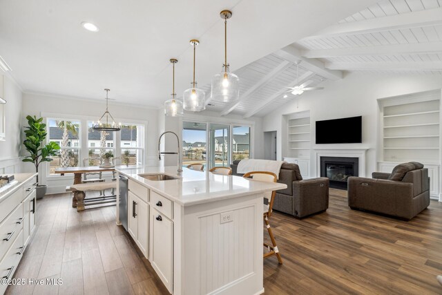 kitchen with a breakfast bar area, dark wood-type flooring, plenty of natural light, and a sink