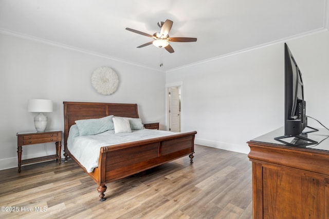 bedroom with crown molding, baseboards, a ceiling fan, and light wood-style floors