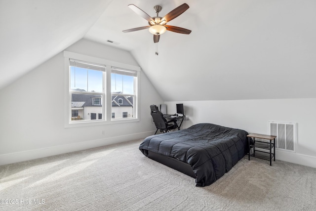 bedroom with carpet, visible vents, a ceiling fan, and lofted ceiling