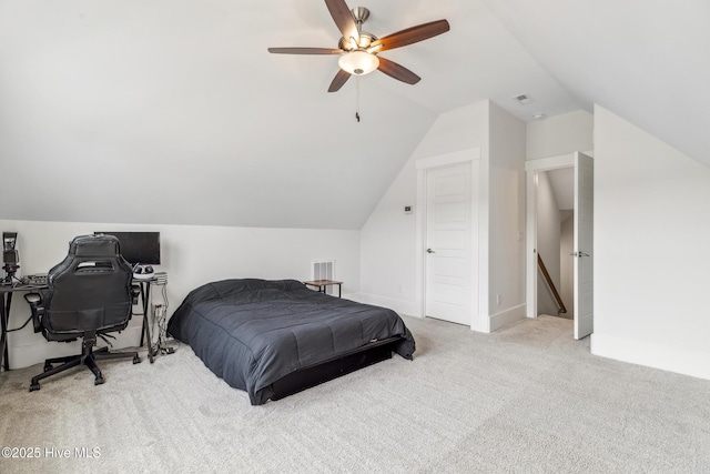 carpeted bedroom featuring visible vents, a ceiling fan, and lofted ceiling