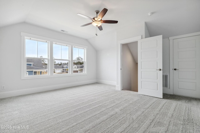 additional living space with visible vents, ceiling fan, and lofted ceiling