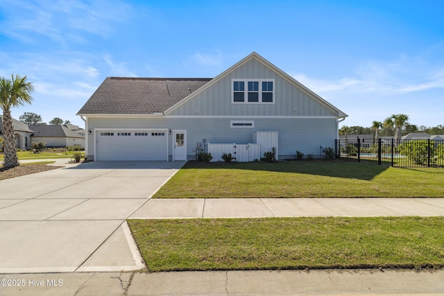 view of front of home with a front lawn, concrete driveway, fence, an attached garage, and board and batten siding