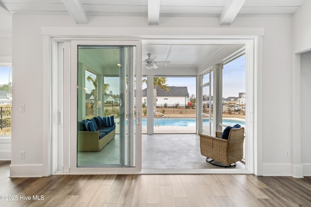 entryway featuring wood finished floors, beamed ceiling, baseboards, and a ceiling fan