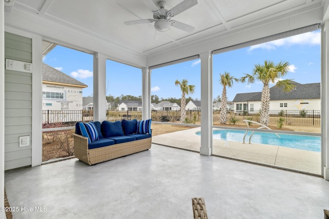 sunroom / solarium featuring a residential view and concrete floors