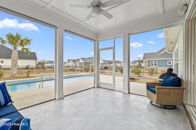 sunroom featuring concrete floors and a residential view