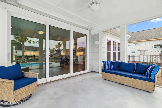 sunroom / solarium with an outdoor living space and ceiling fan