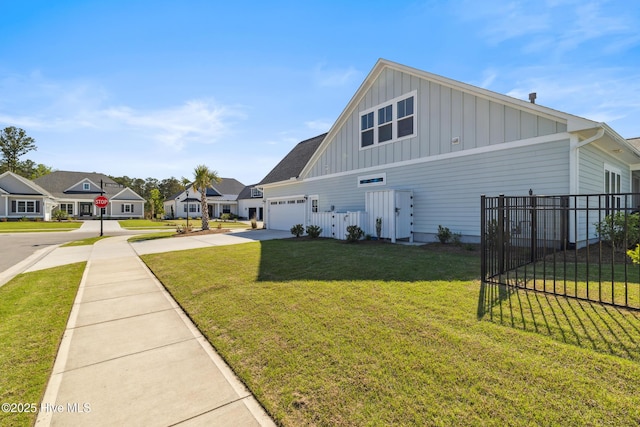 view of property exterior featuring board and batten siding, a garage, a lawn, fence, and concrete driveway