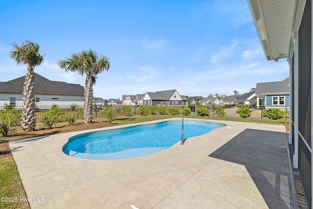 view of swimming pool featuring a fenced backyard, a fenced in pool, a patio, and a residential view