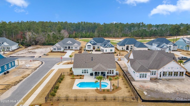 bird's eye view featuring a forest view and a residential view