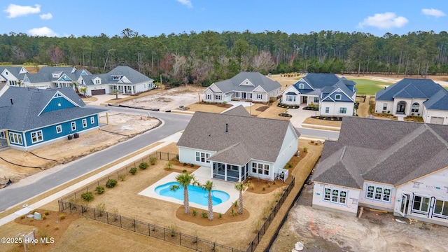 aerial view featuring a residential view and a view of trees
