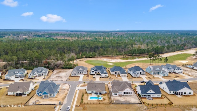 aerial view featuring a view of trees, a residential view, and golf course view