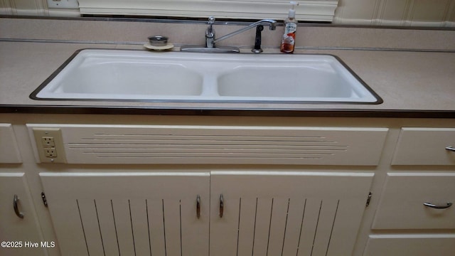 room details featuring a sink and light countertops