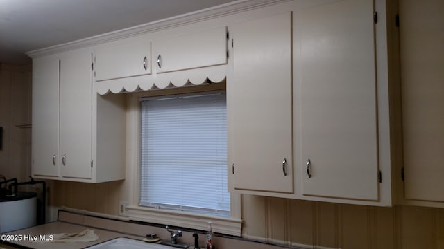 kitchen with white cabinets and water heater