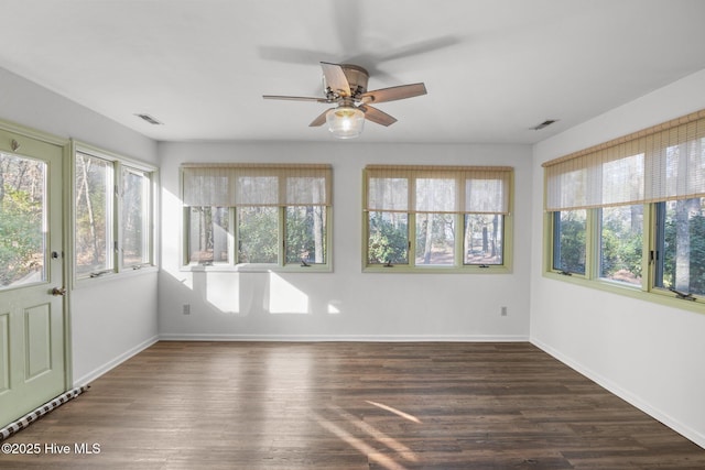 unfurnished sunroom featuring visible vents and ceiling fan