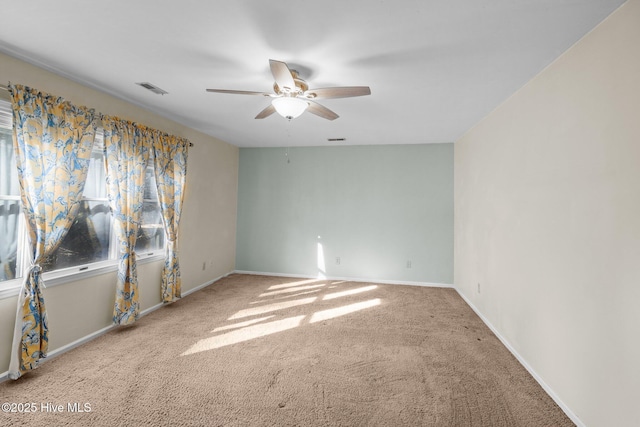 unfurnished room with carpet, baseboards, and ceiling fan