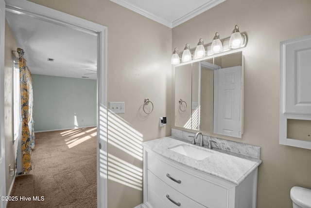 bathroom featuring vanity, toilet, and ornamental molding