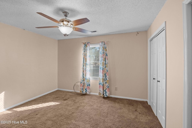 unfurnished bedroom featuring visible vents, a closet, carpet floors, and baseboards