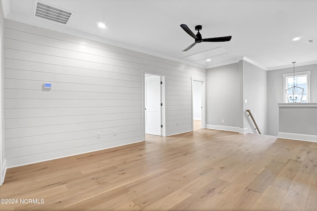 empty room with visible vents, crown molding, baseboards, recessed lighting, and light wood-style floors