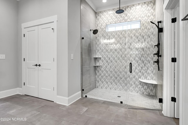 full bath featuring baseboards and a shower stall