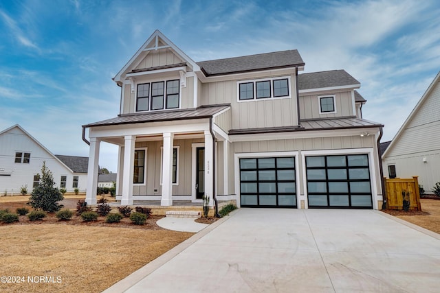 modern inspired farmhouse with metal roof, covered porch, board and batten siding, and a standing seam roof