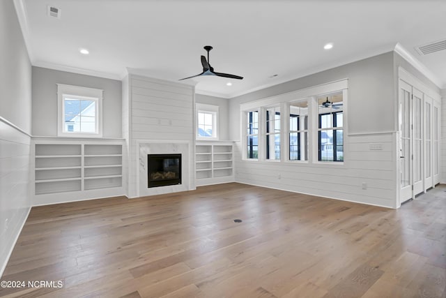 unfurnished living room with visible vents, crown molding, ceiling fan, and wood finished floors