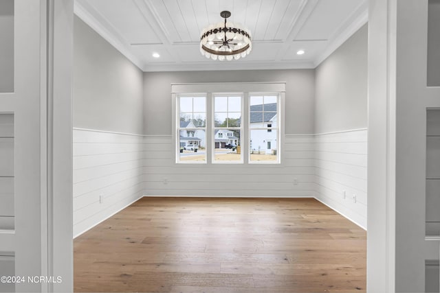 unfurnished room with a chandelier, a wainscoted wall, ornamental molding, hardwood / wood-style floors, and recessed lighting