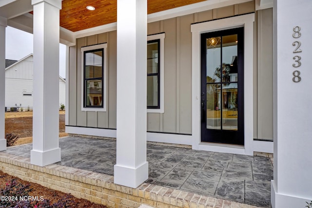 property entrance featuring a porch and board and batten siding