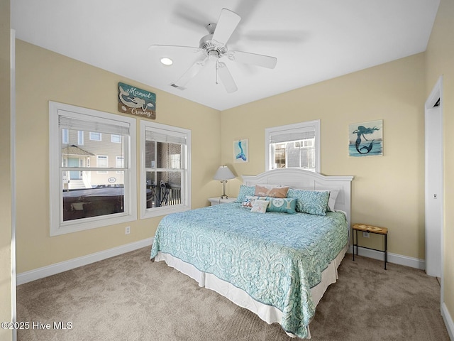 bedroom with carpet flooring, visible vents, a ceiling fan, and baseboards