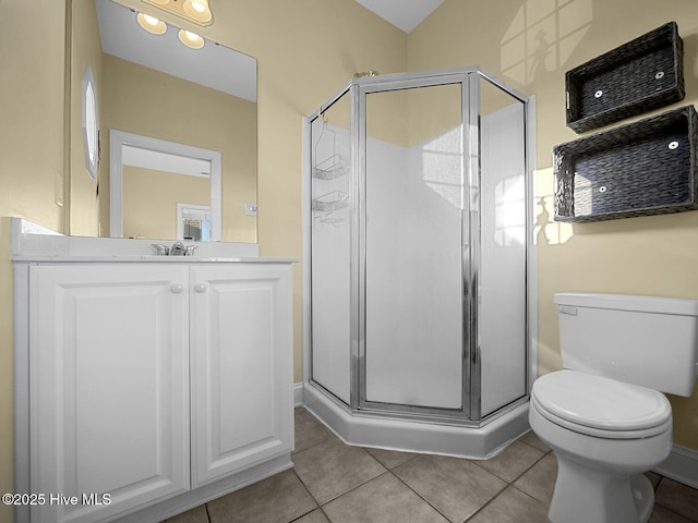 full bathroom featuring tile patterned flooring, toilet, vanity, and a stall shower