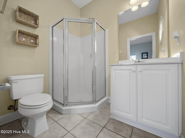 bathroom featuring tile patterned floors, toilet, a stall shower, and vanity