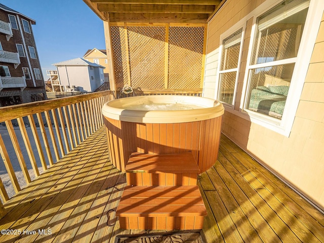 wooden deck with a hot tub