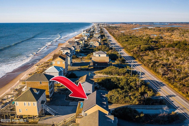 birds eye view of property featuring a water view and a view of the beach