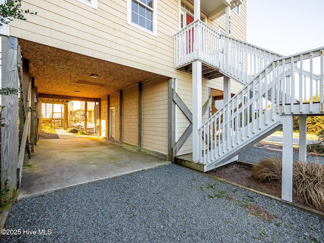 view of side of property featuring stairs and a carport