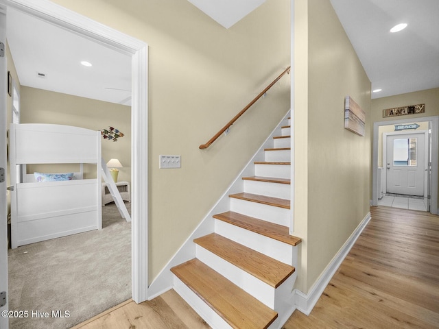 stairs featuring visible vents, recessed lighting, wood finished floors, and baseboards