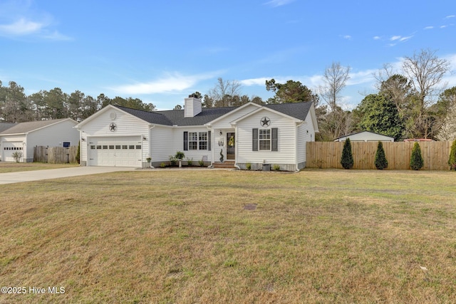 view of front facade with fence, concrete driveway, a front yard, a chimney, and a garage